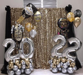 Organic balloon year sculpture with black, gold, and silver chrome balloons for New Year’s Eve decor